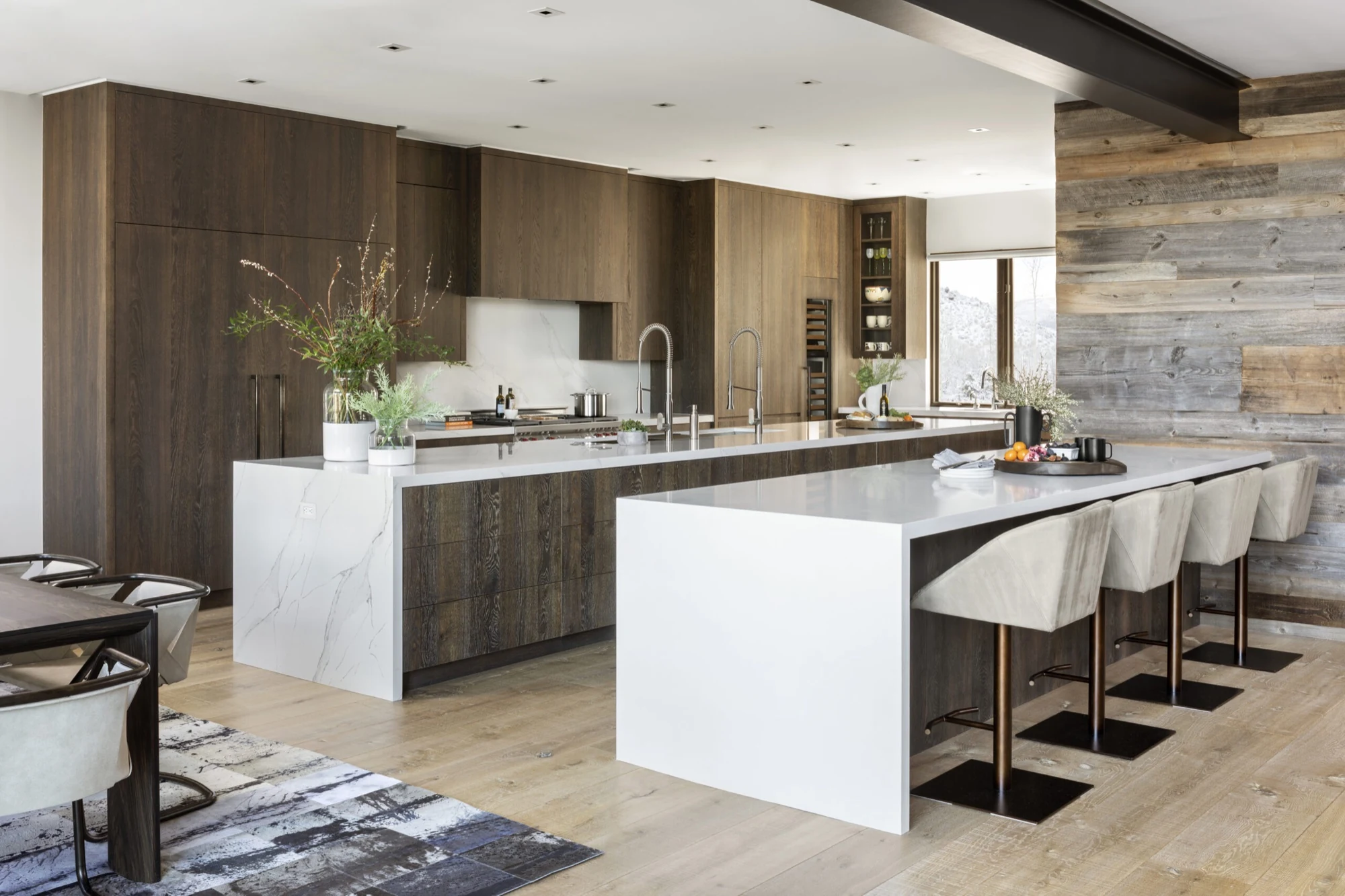 Wiltshire Beaver Creek kitchen with dark wood cabinetry, dual islands, and custom wine storage