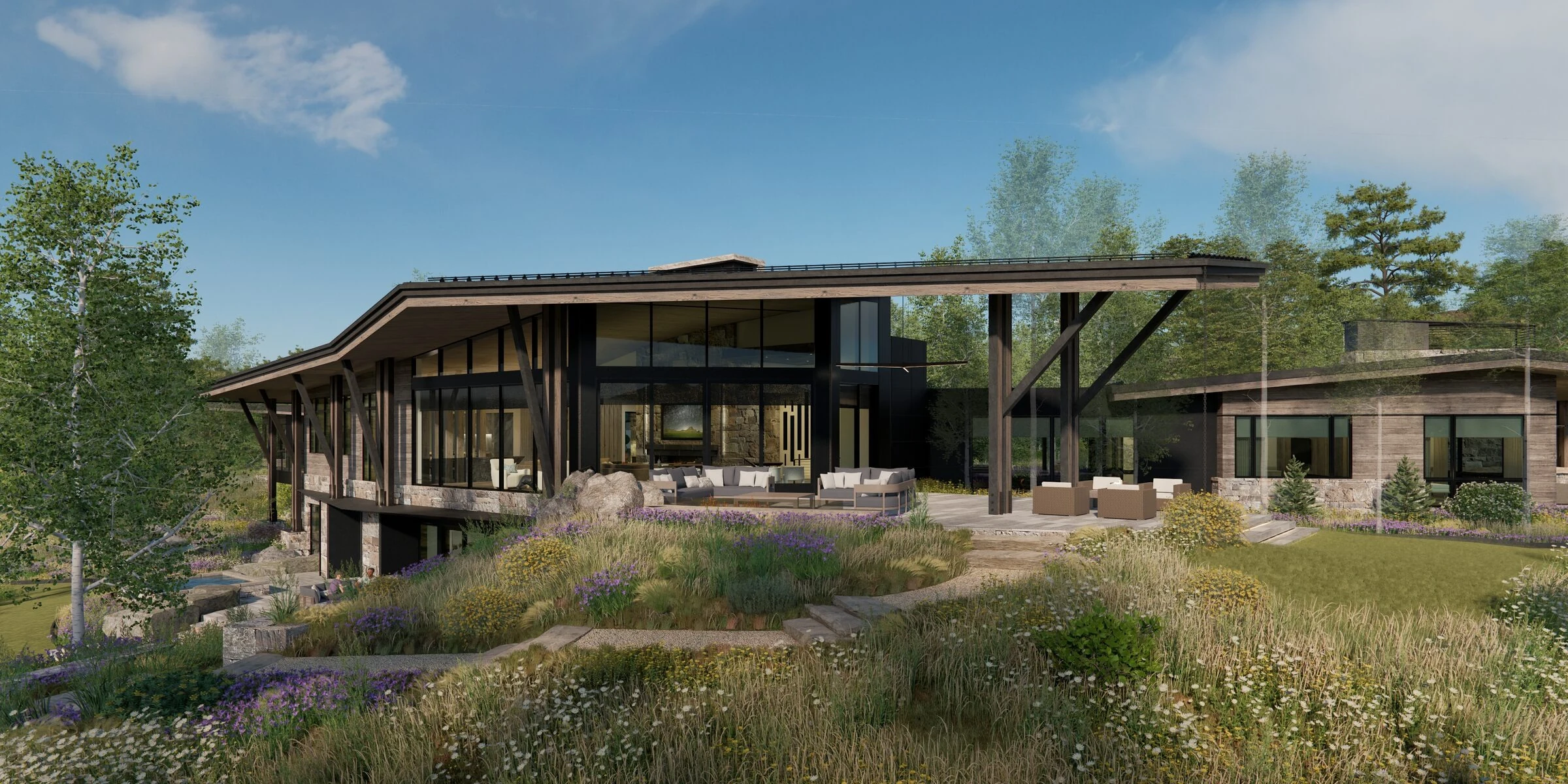 Mountain home back exterior with covered deck and meadow