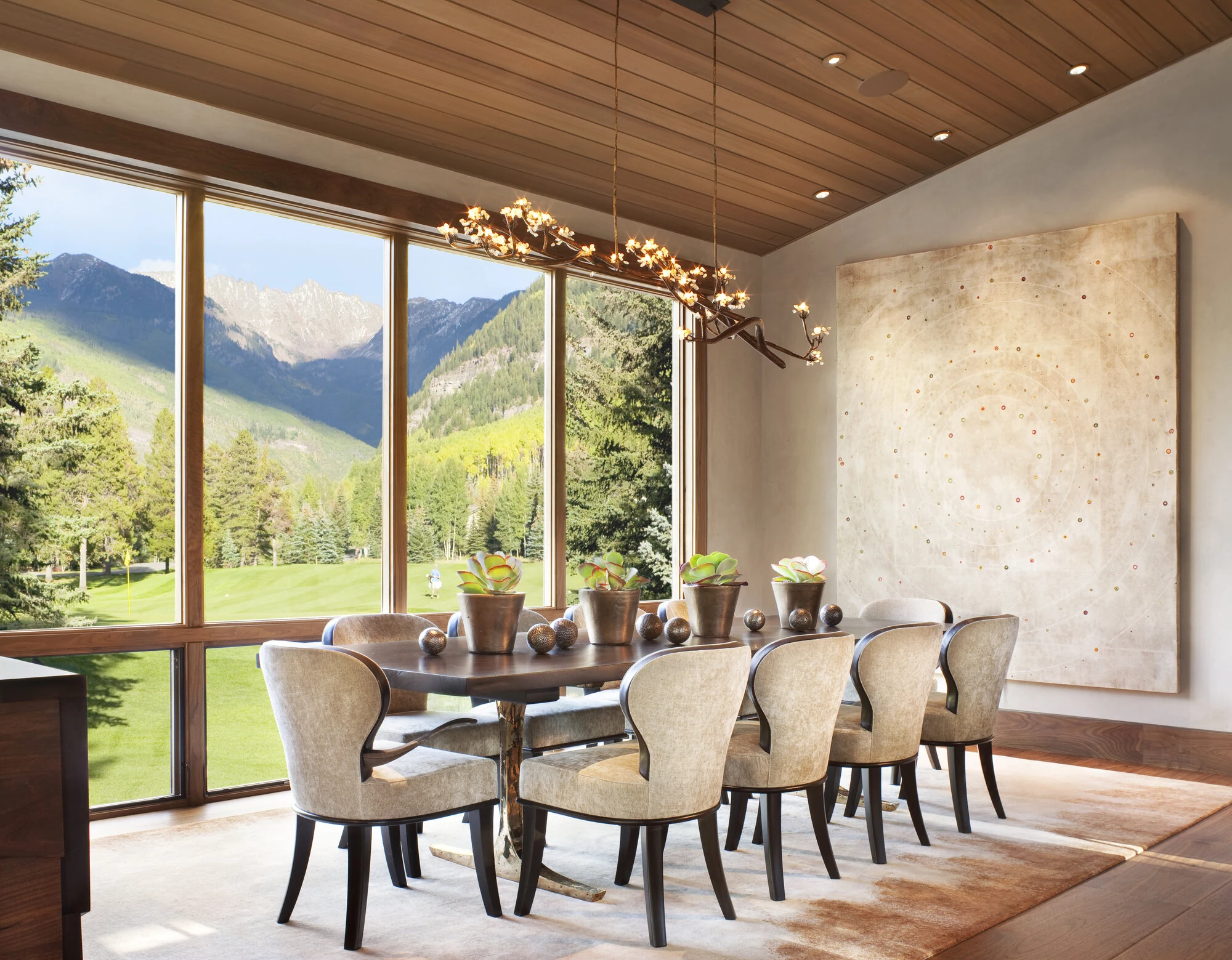 Natural Instincts living room with walnut doors and mountain views