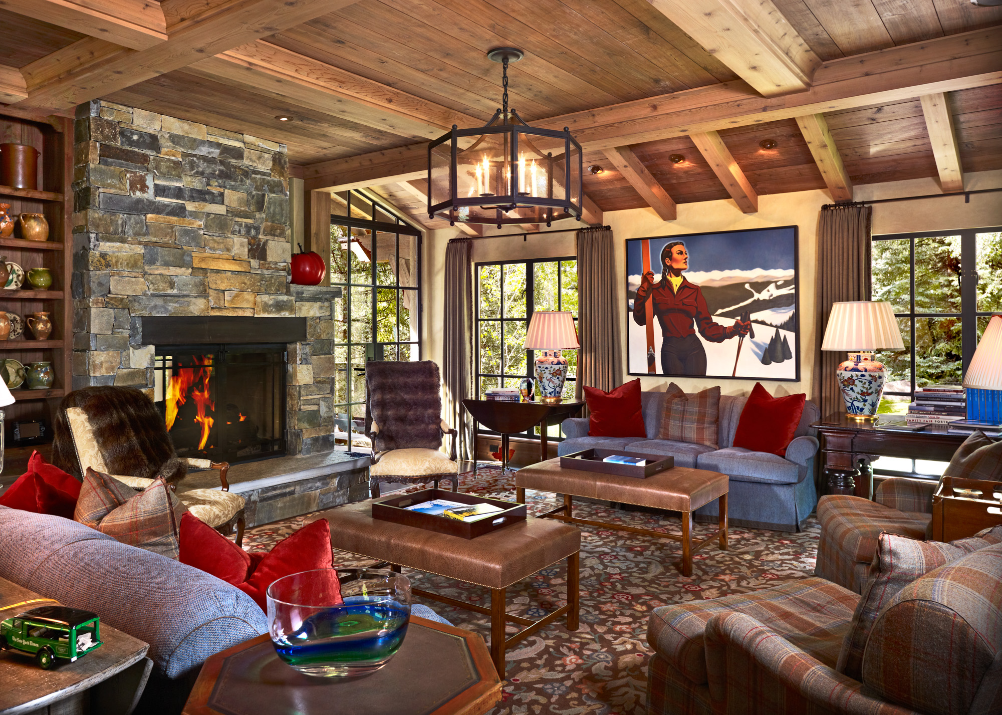 a richly decorated mountain rustic style living room with a stone fireplace at hornsilver