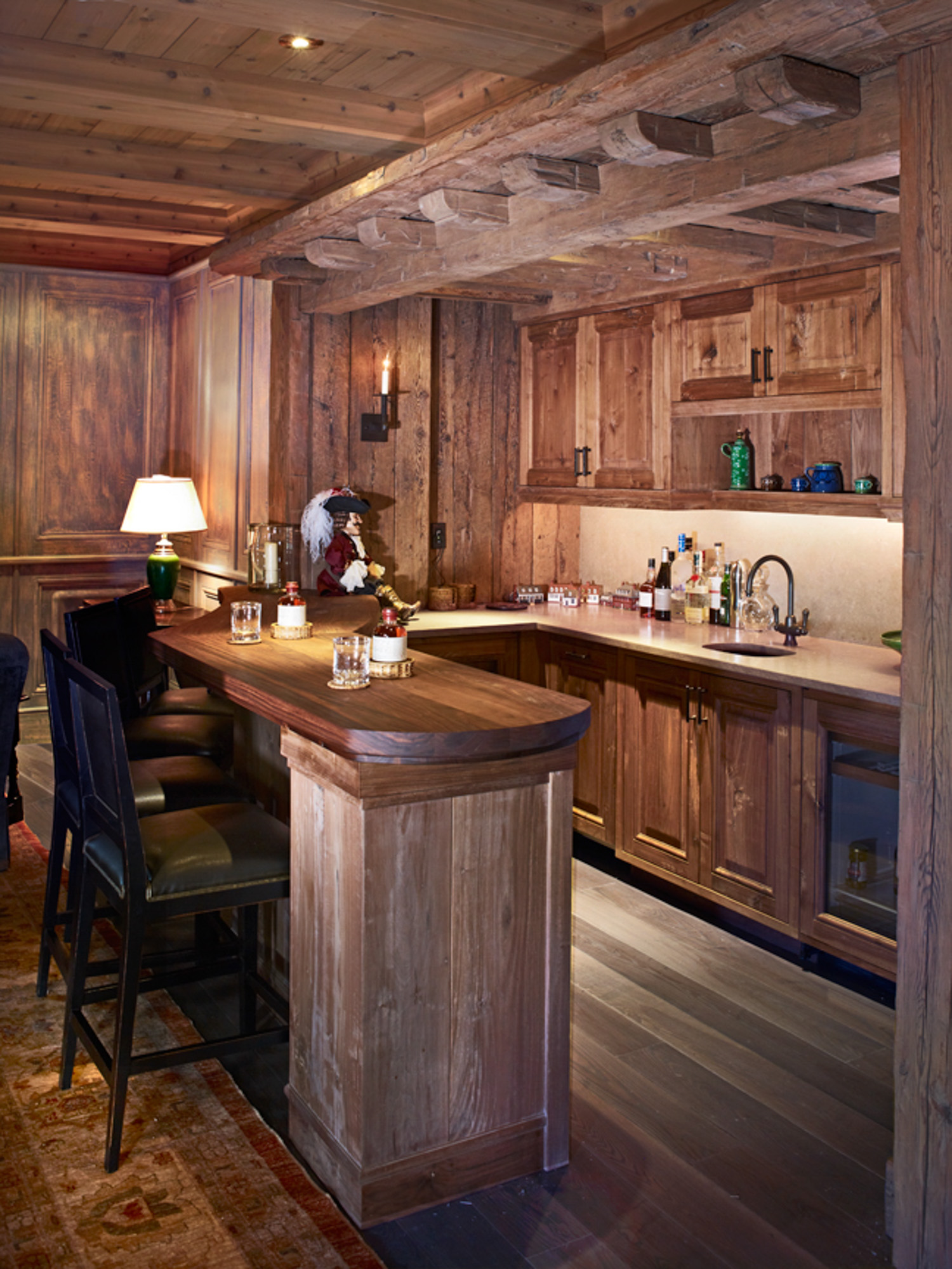 A rustic-style kitchen with brown wooden cabinets and a wooden beamed ceiling at hornsilver