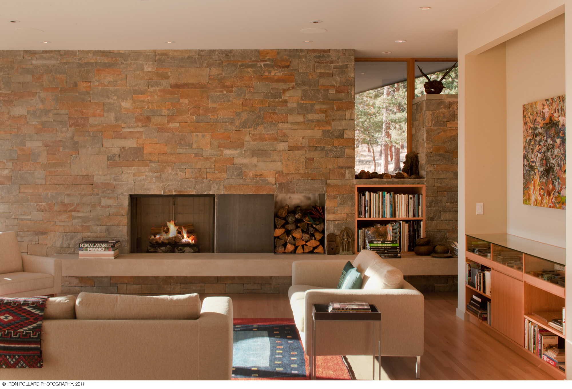 A large contemporary fireplace with low contemporary furniture surrounding it at williams ridge