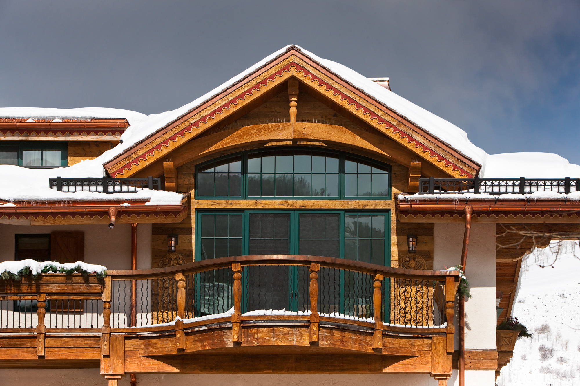 an exterior view of french doors and a deck in the Bell Tower project in Vail, CO