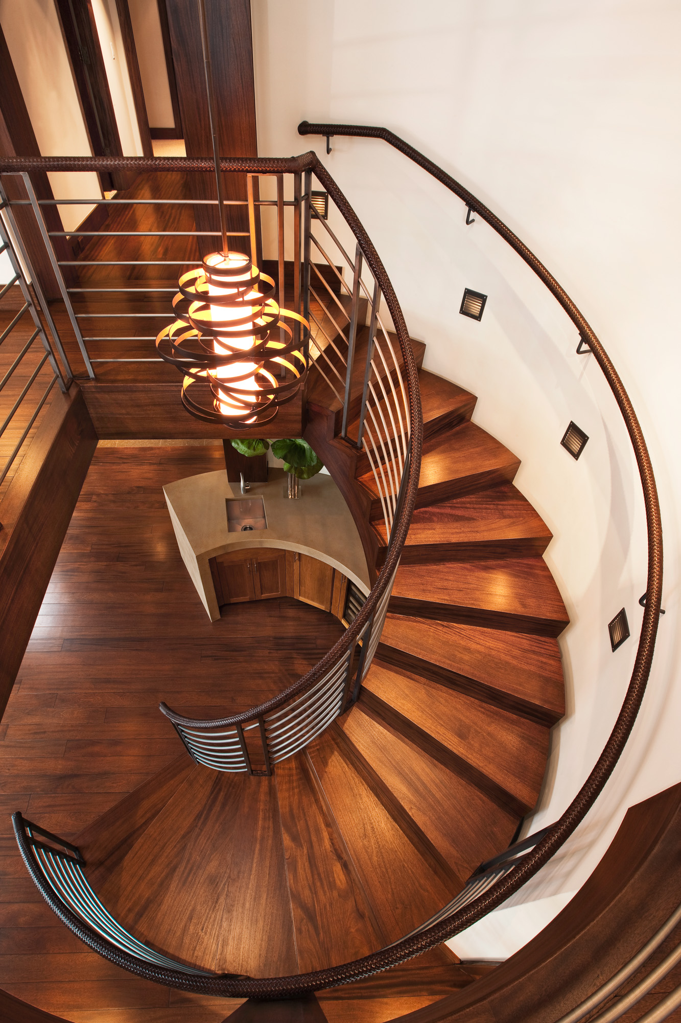 an overhead view of a dark wood spiral staircase in the Bell Tower project in Vail, CO