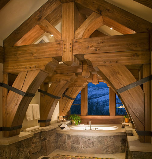 thick wooden beams with iron ties over a large bathtub with dramatic views at royal elk