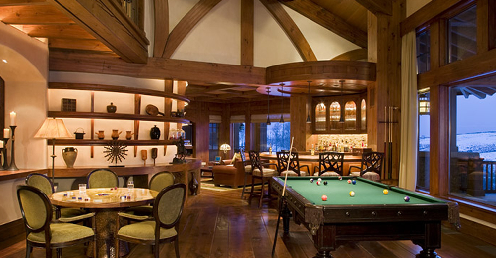 a pool table and poker table in a colorado traditional room at royal elk