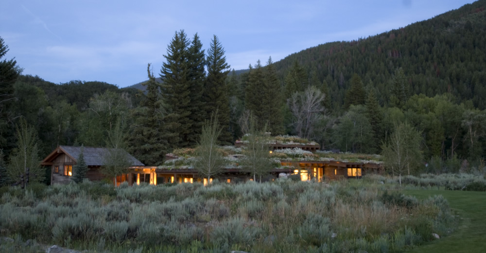 an exterior view of mountain modern home watersong at dusk