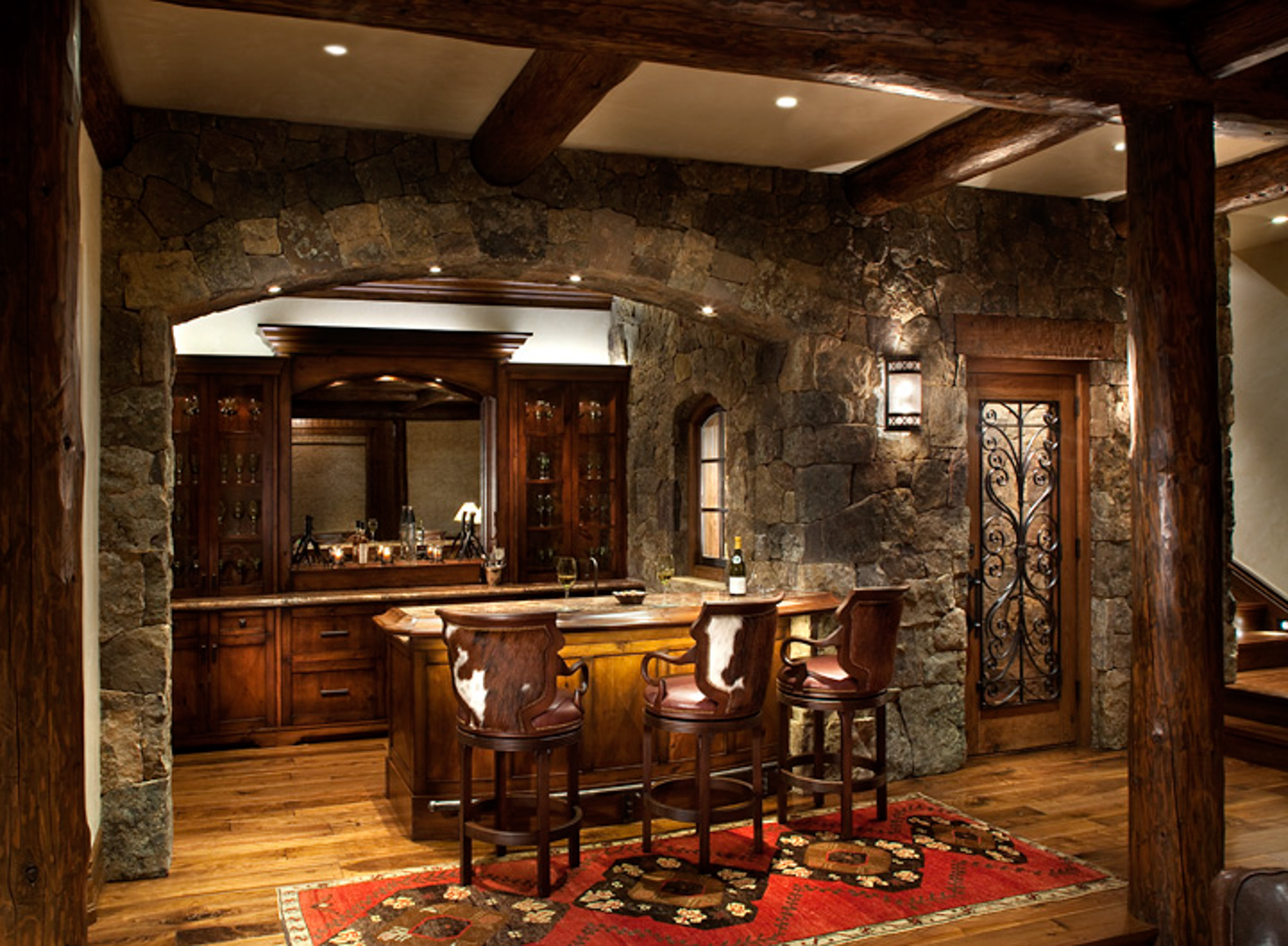 A view of an old-fashioned wooden bar with stone surround in bachelor gulch