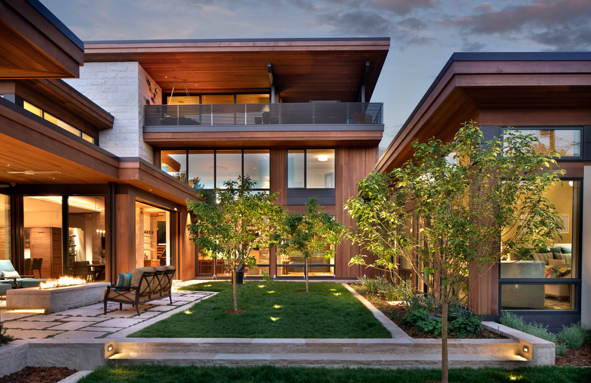 the back yard of the urban color project, featuring a a garden area with trees